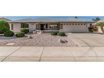 Charming single-story home featuring manicured landscaping and a two-car garage, perfect for suburban living at 11529 E Lindner Ave, Mesa, AZ 85209