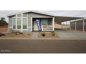 Well-maintained home features a covered parking area and desert landscaping, offering both convenience and curb appeal at 1820 N Thornton Rd # 917, Casa Grande, AZ 85122