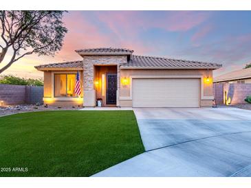 Charming single-story home featuring a manicured lawn, stone accents, and a two-car garage at 2024 E Cherry Hills Pl, Chandler, AZ 85249