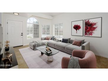 Bright living room with a gray modular sofa, marble coffee table, and large window at 3755 E Broadway Rd # 21, Mesa, AZ 85206