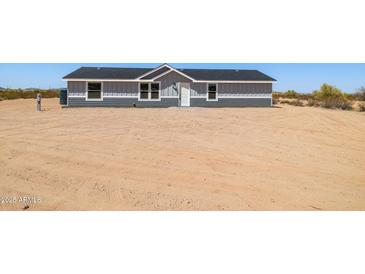 Charming single-story home with gray siding and a well-maintained, xeriscaped front yard at 51288 W Bluejay St, Maricopa, AZ 85139