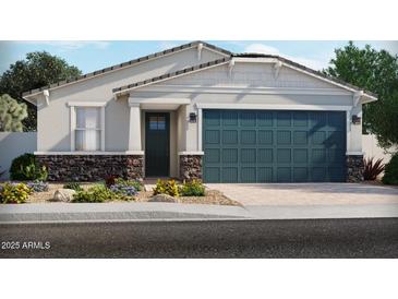 Charming single-story home featuring a two-car garage, stone accents, and a beautifully landscaped front yard at 5511 S 246Th Ave, Buckeye, AZ 85326