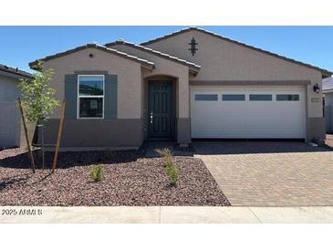 Charming single-story home featuring a two-car garage and professionally landscaped front yard at 5537 S 246Th Ave, Buckeye, AZ 85326