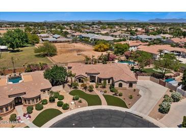 Sprawling single-story home with lush landscaping, manicured lawns, and a circular driveway at 5755 S Pearl Dr, Chandler, AZ 85249