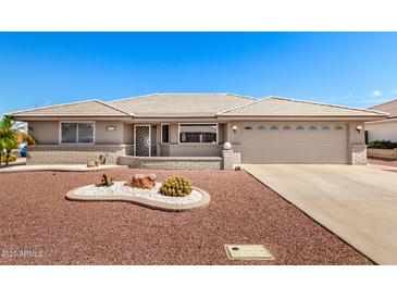 Charming single-story home with desert landscaping, a two-car garage, and a neutral color palette at 11510 E Lomita Ave, Mesa, AZ 85209