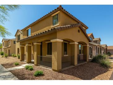 Inviting two-story home featuring a covered porch with stylish columns and low maintenance desert landscaping at 17878 N 114Th Ln, Surprise, AZ 85378