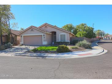 Charming single-story home with a well-maintained front yard and attached two-car garage at 18116 N Catherine Dr, Surprise, AZ 85374