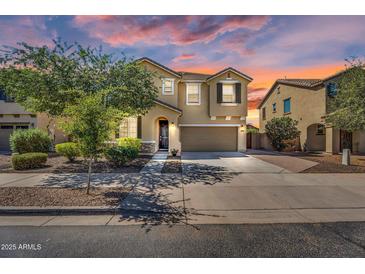 Charming two-story home with a well-maintained front yard and a spacious two-car garage at 21031 E Creekside Dr, Queen Creek, AZ 85142