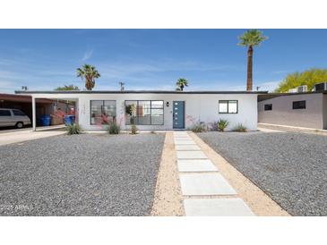 Charming single-story home with xeriscaped yard and a walkway leading to the front door at 2320 E Mulberry Dr, Phoenix, AZ 85016