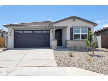 Charming single-story home featuring a well-maintained yard and a two-car garage at 37069 W Prado St, Maricopa, AZ 85138