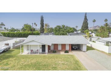Charming single-story home featuring a carport and well-maintained front lawn at 4010 E Catalina Dr, Phoenix, AZ 85018