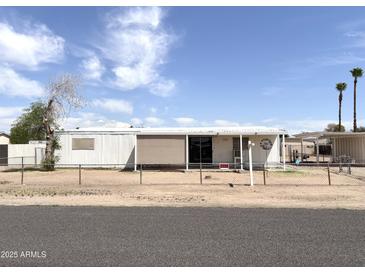 Charming single-story home with a fenced yard and covered porch, perfect for outdoor living at 6950 W Karen Lee Ln, Peoria, AZ 85382
