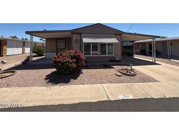 Charming single-story home featuring a covered carport and well-maintained landscaping at 8103 E Southern Ave # 157, Mesa, AZ 85209