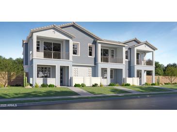 Charming two-story townhomes with private balconies and manicured lawns in a desirable neighborhood at 8149 E Petunia Ave # 1057, Mesa, AZ 85212