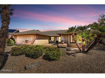 Beautiful single-story home featuring desert landscaping, a quaint porch, and a two-car garage at 9226 W Topeka Dr, Peoria, AZ 85382