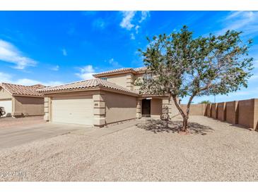 Charming two-story home featuring a two-car garage, desert landscaping, and a classic tile roof at 11501 N Pablo St, El Mirage, AZ 85335