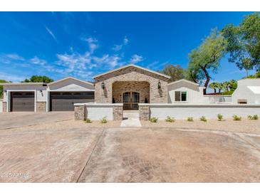 Charming single-story home with brick and stone accents, a well-manicured yard, and a welcoming entrance at 13238 N 78Th St, Scottsdale, AZ 85260