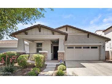 Charming single-story home with a well-maintained front yard and a two-car garage at 14793 W Surrey Dr, Surprise, AZ 85379