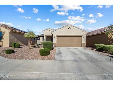 Inviting single-story home featuring low-maintenance landscaping and a two-car garage at 1601 S 215Th Dr, Buckeye, AZ 85326