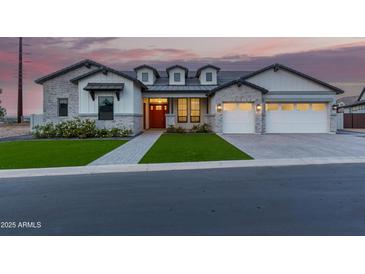 Stunning single-Gathering home with charming curb appeal, green lawn, and a welcoming red door at 1704 E Melrose St, Mesa, AZ 85203