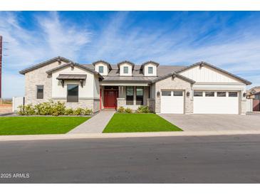 Well-maintained single-Gathering home featuring a manicured lawn, red front door, and a three-car garage at 1704 E Melrose St, Mesa, AZ 85203