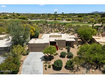 Desert home boasts golf course views, lush landscaping, and private driveway at 1725 E Staghorn Ln, Carefree, AZ 85377