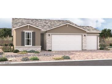 Charming single-Gathering home with a stone-accented facade and three-car garage on a beautifully landscaped lot at 18189 W Hess St, Goodyear, AZ 85338