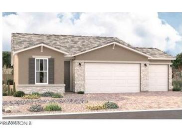 Charming single-story home with a two-car garage and professionally landscaped front yard at 18204 W Hess St, Goodyear, AZ 85338