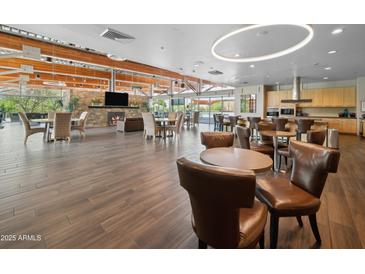 Spacious clubhouse lounge features a stone fireplace, seating areas, and a convenient kitchenette at 21817 N 39Th St, Phoenix, AZ 85050