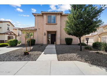 Charming two-story home with desert landscaping and a welcoming walkway to the front door at 26408 N 53Rd Gln, Phoenix, AZ 85083