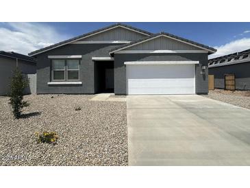 Charming single-story home featuring a well-maintained yard and an attached two-car garage at 46922 W Coe St, Maricopa, AZ 85139