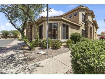 Charming home exterior featuring a tiled roof, manicured landscaping, and a welcoming front yard at 5415 E Mckellips Rd # 100, Mesa, AZ 85215