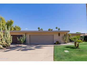 Charming single-story home featuring desert landscaping with mature cacti and a well maintained front yard at 7615 E Tucson Rd, Scottsdale, AZ 85258