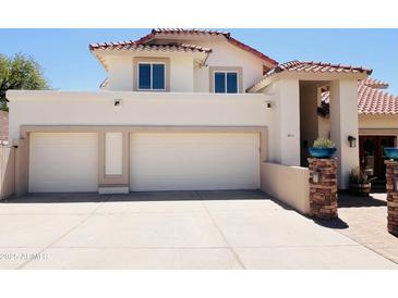 Inviting home featuring a spacious three car garage and tile roof at 1221 E Claire Dr, Phoenix, AZ 85022