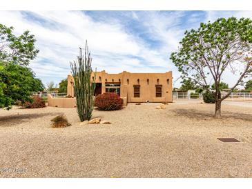 Charming tan home featuring desert landscaping, blue skies, and a welcoming ambiance at 16222 W Augusta Ave, Litchfield Park, AZ 85340