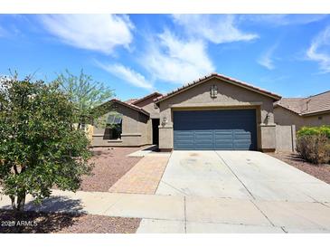 Charming single-story home with a well-maintained yard and attached two-car garage at 16418 W Whitehorn Way, Surprise, AZ 85387