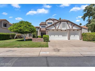 Charming two-story home featuring a three-car garage, manicured lawn, and beautiful curb appeal at 19920 N 69Th Ave, Glendale, AZ 85308
