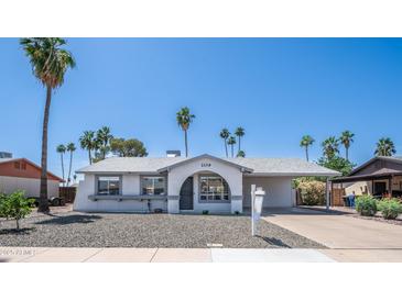 Charming single-story home featuring desert landscaping, neutral paint, and a covered carport at 2139 W Obispo Ave, Mesa, AZ 85202