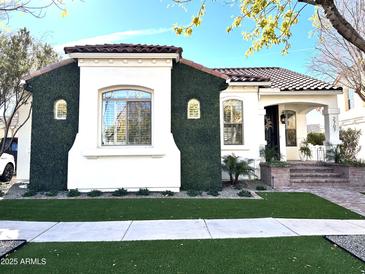Charming home exterior with well-manicured greenery, a brick pathway and a clay tile roof at 2707 E James St, Gilbert, AZ 85296