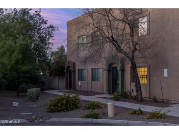 Charming two-story townhouse with beautiful desert landscaping and inviting entryway at 2826 E Tracy Ln # 3, Phoenix, AZ 85032
