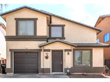 Charming two-story home features a well-maintained front yard, inviting entrance, and attached garage, offering curb appeal and convenience at 4925 S 5Th Ave, Phoenix, AZ 85041