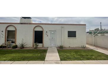 Charming single-story home featuring well-maintained landscaping, desert accents, and a secure front entrance at 8050 E Oak St, Scottsdale, AZ 85257