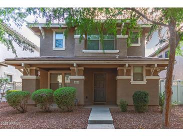 Inviting two-story home featuring a covered porch and well-manicured landscaping at 999 S Sabino Dr, Gilbert, AZ 85296