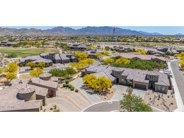Expansive aerial shot highlighting the home's desert landscape, paver driveway, golf course, and surrounding community at 12325 S 179Th S Ave # 0, Goodyear, AZ 85338