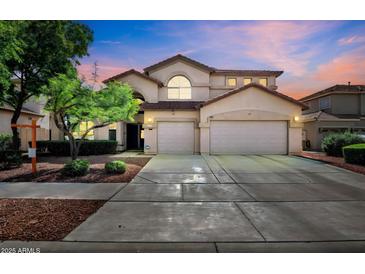 Charming two-story home with a three car garage and landscaped front yard at 13965 N 135Th Dr, Surprise, AZ 85379