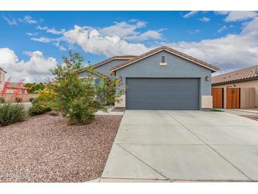 Charming single-story home featuring desert landscaping and a two-car garage, perfect for first-time homebuyers at 18415 W Surprise Farms N Loop, Surprise, AZ 85388