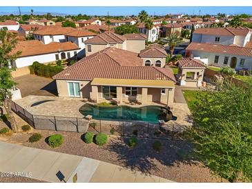 Inviting pool with a wrought iron fence and desert landscaping at 2111 E Azalea Dr, Chandler, AZ 85286