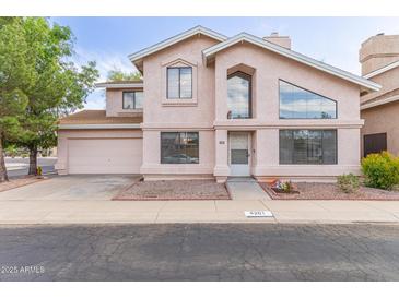 Two-story home featuring a two car garage, well-manicured lawn, and covered entrance at 4201 W Renee Dr, Glendale, AZ 85308