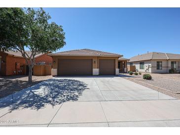 Charming single-story home featuring a three-car garage, tile roof, and low-maintenance desert landscaping at 45633 W Mountain View Rd, Maricopa, AZ 85139
