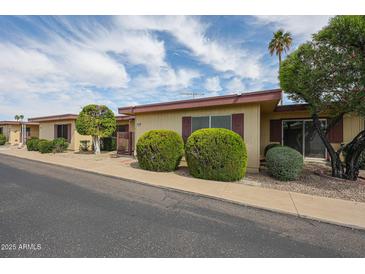 Charming single-story home featuring desert landscaping, a gated entryway, and lovely curb appeal at 13618 N 98Th Ave # C, Sun City, AZ 85351
